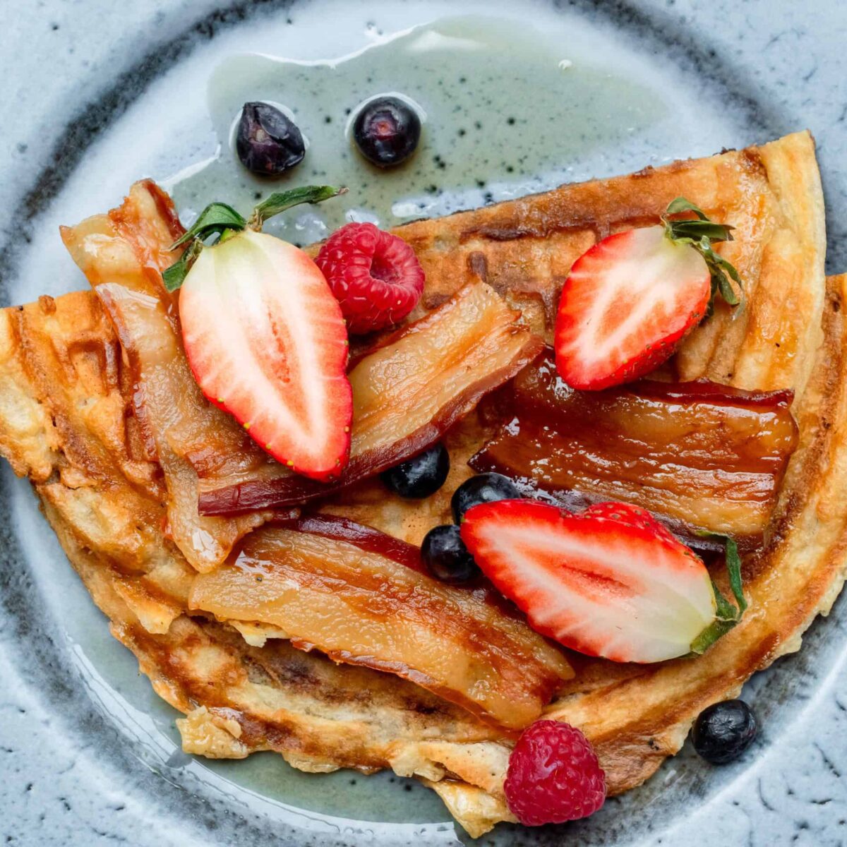 Pancakes with berries, bacon and maple syrup