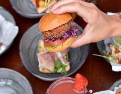 Burger in Hand and Cocktails