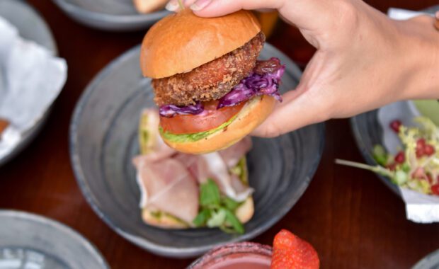 Burger in Hand and Cocktails